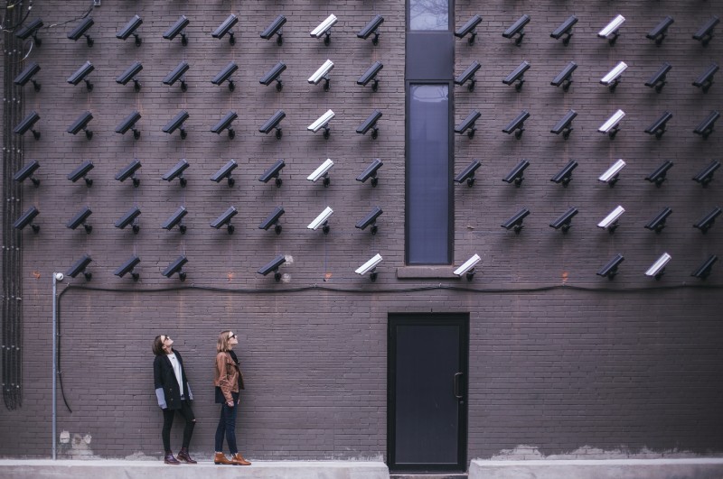 Two women facing security cameras